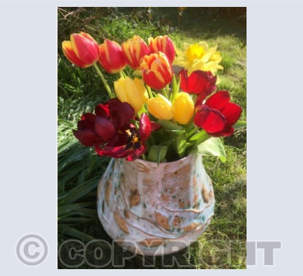 April tulips in stoneware vessel