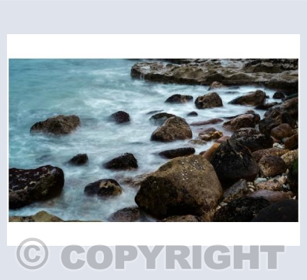 Dreamy waves over Portland rocks